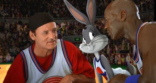 UNSPECIFIED - JANUARY 26:  Medium shot of Bill Murray as Himself wearing hat/baseball cap, huddled with Bugs Bunny and Michael Jordan; all wearing basketball uniforms in front of crowd. (Filmframe).  (Photo by Warner Bros./Getty Images)