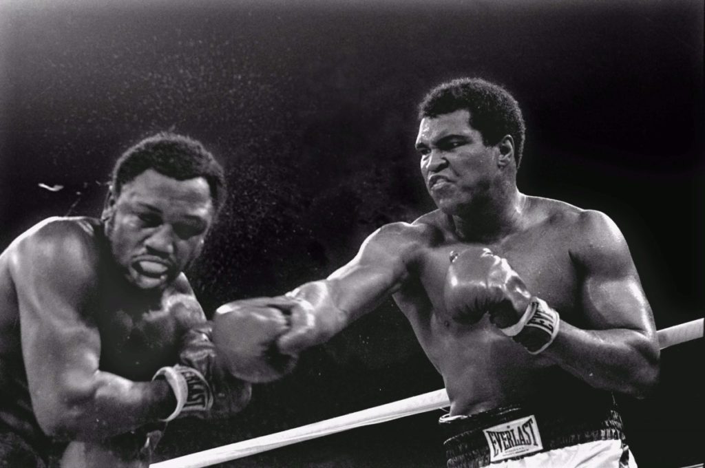 FILE--Spray flies from the head of challenger Joe Frazier as heavyweight champion Muhammad Ali connects with a right in the ninth round of their title fight in Manila, Philippines, October 1, 1975.  Ali won the fight on a decision to retain the title. Frazier was arrested for drunken driving early Tuesday morning, April 7, 1998, after being pulled over for driving erratically down a North Philadelphia street. The ex-boxer, who also runs Joe Frazier's Gym in Philadelphia, was later taken to Thomas Jefferson University Hospital after complaining of problems related to his high-blood pressure, authorities said. (AP Photo/Mitsunori Chigita)