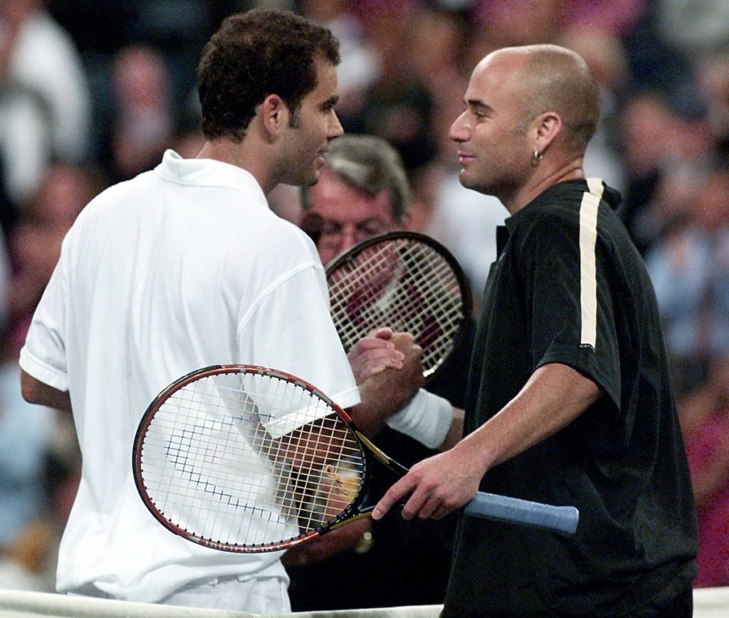 FLUSHING MEADOWS, UNITED STATES:  Number ten seeded Pete Sampras (L) of the US and number two seeded Andre Agassi (R) of the  US shake hands at the net at the end of their match 05 September, 2001, at the US Open in Flushing Meadows, New York. Sampras won 6-7, 7-6, 7-6, 7-6.   AFP PHOTO/Don EMMERT (Photo credit should read DON EMMERT/AFP/Getty Images)