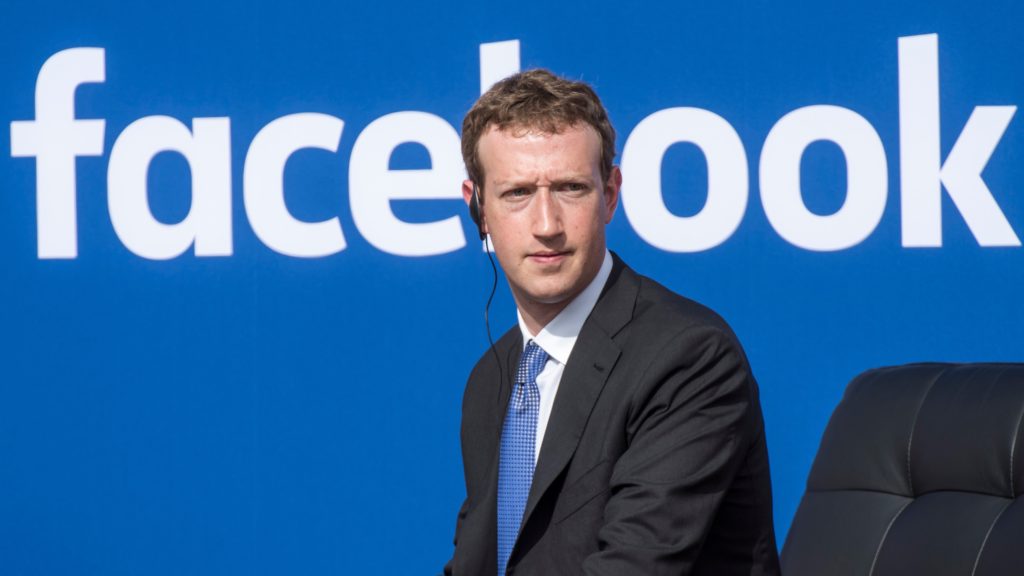 Mark Zuckerberg, chief executive officer of Facebook Inc., listens as Narendra Modi, India's prime minister, not pictured, speaks during a town hall meeting at Facebook headquarters in Menlo Park, California, U.S., on Sunday, Sept. 27, 2015. Prime Minister Modi plans on connecting 600,000 villages across India using fiber optic cable as part of his "dream" to expand the world's largest democracy's economy to $20 trillion. Photographer: David Paul Morris/Bloomberg *** Local Caption *** Mark Zuckerberg
